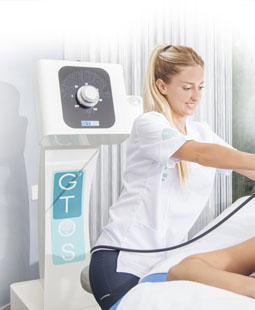 Close-up of female therapist examining hand on white towel at hospital ward